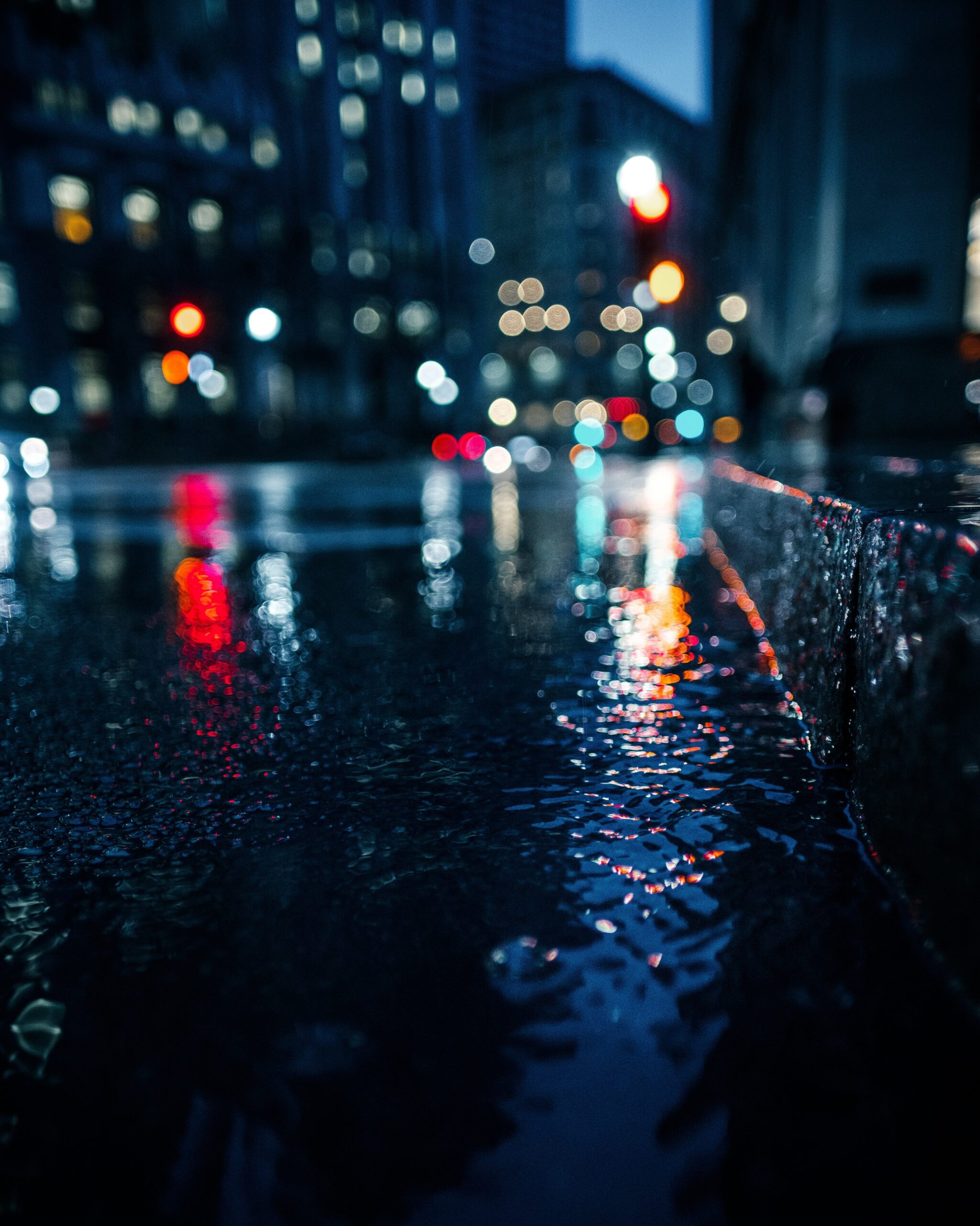 A rainy night street illuminated by street lights